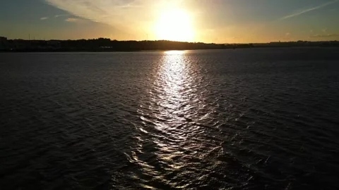 Flying over water at sunset Stock Footage 304446159