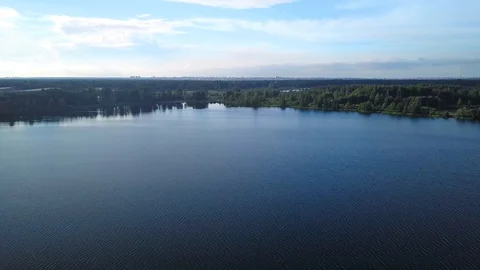 Flying over water surface of forest blue lake Stock Footage 97972339