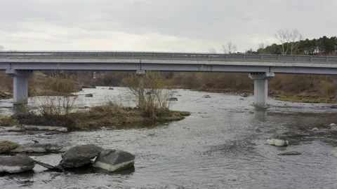 Flying over the water under a road bridge Stock Footage 134036640