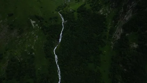 Flying over the waterfall on the green mountain Stock Footage 307878468