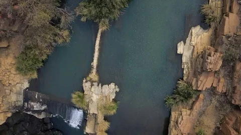 Flying over waterfall looking directly down into gorge Video stock 78584696