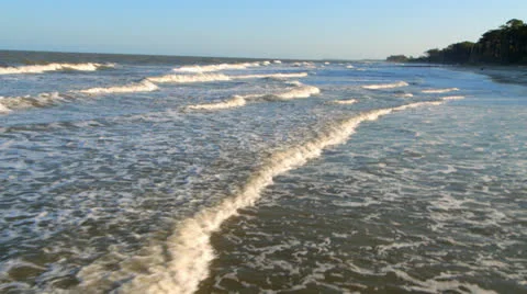 Flying over waves on the beach with a helicopter low altitude Stock Footage 26455795