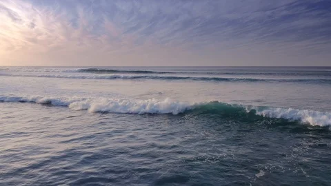 Flying over the Waves of the Ocean to the Sun and the sea Aerial view 4K Stock Footage 126478690