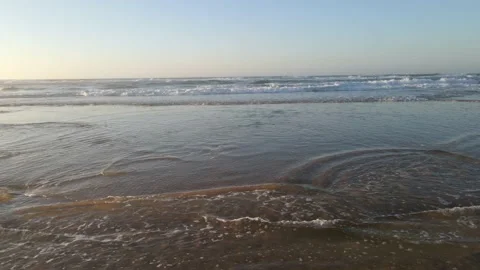 Flying over the waves reaching the beach Stock Footage 170707853