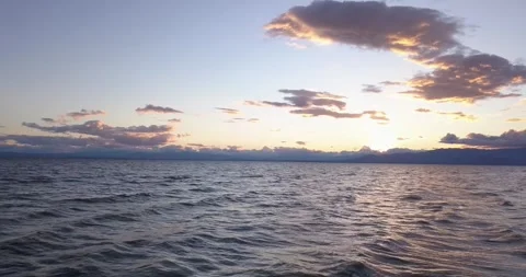 Flying over the waves of the Salton Sea at sunset Video stock 276854591