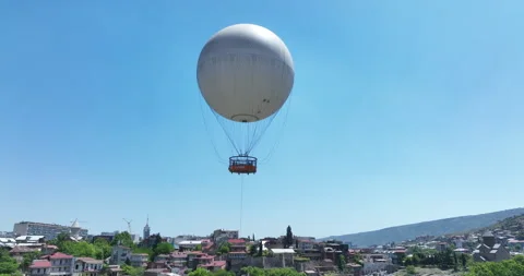 Flying over white balloon in the center of city. Morning cityscape of Tbilisi Stock Footage 199019268