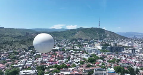 Flying over white balloon in the center of city. Morning cityscape of Tbilisi Video stock 199021501