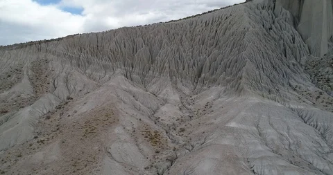Flying over white desertic mountain slope with strange linear natural drawings 스톡 동영상 103493577