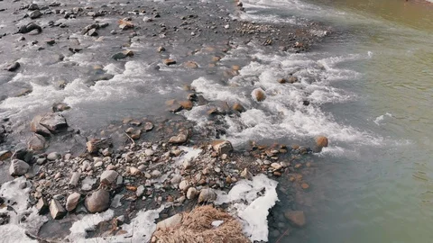 Flying over Wild Mountain River Flowing with Stone Boulders and Rapids Stock Footage 125939416