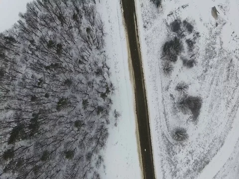 Flying over winter forest and the road Video stock 74053069