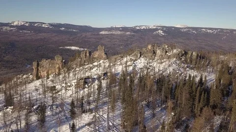 Flying over winter mountain ridge to the valley Stock Footage 84178516