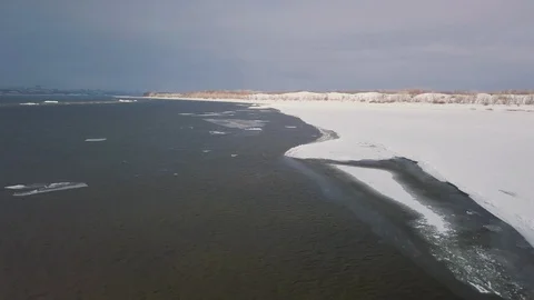 Flying over the winter river shooting video from a drone Stock Footage 123127700