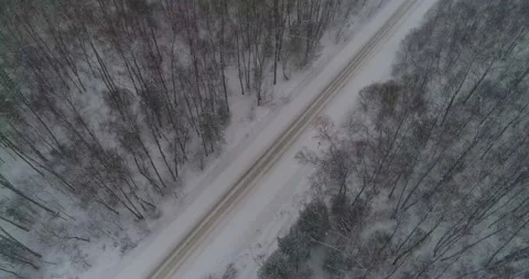 Flying over the winter road, with active snowfall Stock Footage 147715914