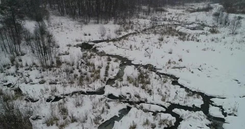 Flying over a winter small river Stock Footage 147693569