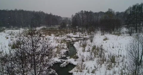 Flying over a winter small river Stock Footage 147694158