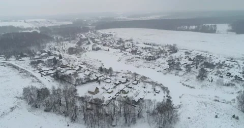 Flying over the winter village, with active snowfall Stock Footage 147697089