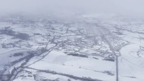 Flying Over a Wintry City in Misty Conditions Stock-Footage 325575323