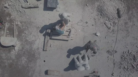 Flying over working sculptors Stock Footage 92125301