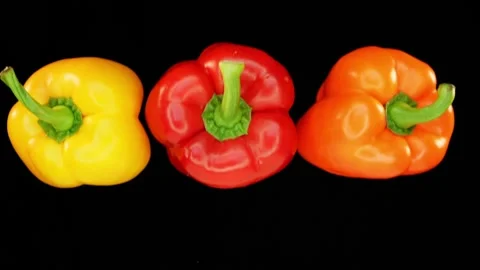 Flying paprika infront of black background in slowmotion Stock Footage 163202830