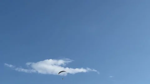 Flying paraglider on the background of blue sky and clouds. Stock Footage 231781255
