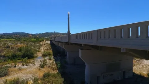 Flying Parallel to a bridge 1 Tracking back with moving cars Stock Footage 74782792