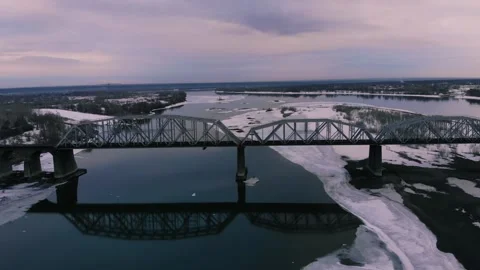 Flying parallel to the railway bridge over the river Stock Footage 252317914
