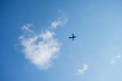 Flying passenger plane on blue sky background Stock Photos