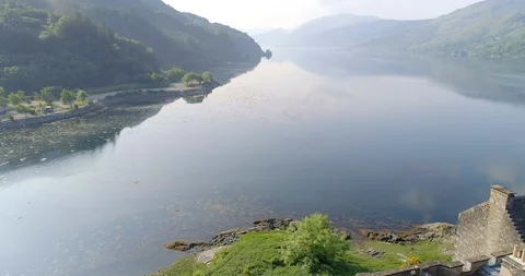 Flying Past Eilean Donan Castle on Loch Duich Stock Footage 98122809