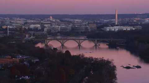 Flying past the Key Bridge over the Potomac River at dusk in Washington DC; left Stock Footage