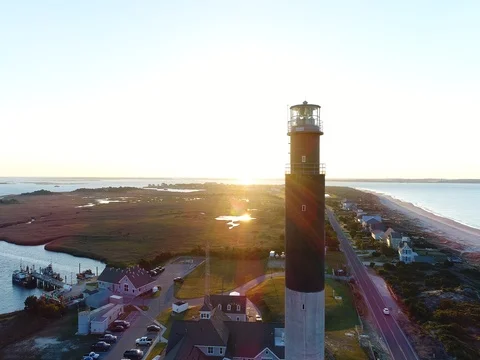 Flying past a lighthouse at sunrise Stock Footage 73686183