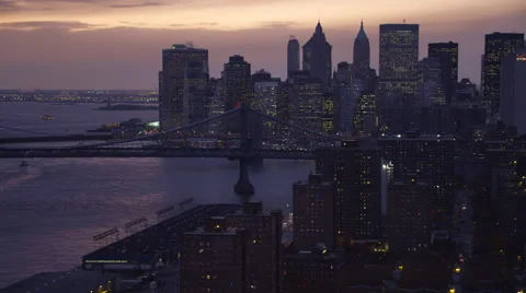 Flying past Manhattan Bridge at dusk,  skyline of Financial District in Stock Footage 59171469