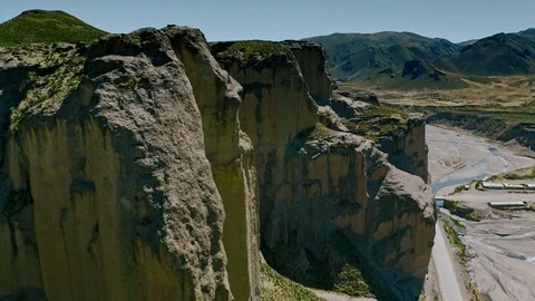 Flying past massive rock cliffs in the Colca Canyon Stock Footage 115369924