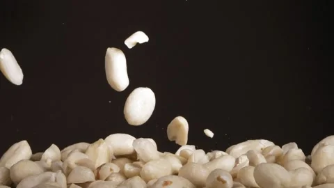 Flying peanuts on a dark background. Super slow motion. Stock Footage 150182943