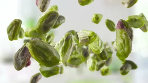 Flying of Peeled Pistachios in Kitchen Background Stock Footage 148546840