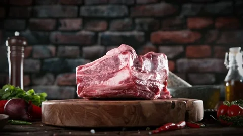 Flying piece of raw beef steak falling on table Stock Footage 169670534