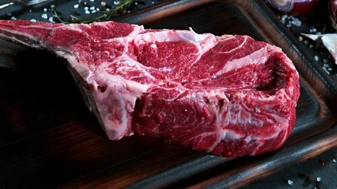 Flying piece of raw beef tomahawk steak. Stock Footage 123548589