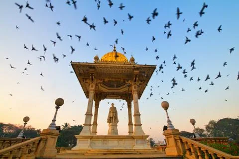 Flying Pigeons. Pigeons flocking around Krishna Raja Wadiys statue Stock Photos