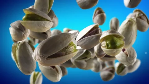 Flying of Pistachios in Blue Background Stock Footage 147484021