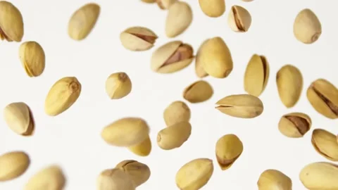 Flying pistachios on the white background slow motion Video stock 148553347