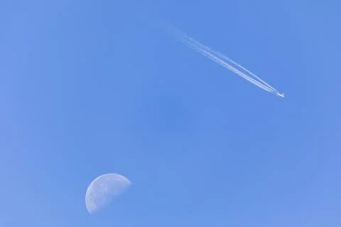 Flying plane on the background of the moon Stock Photos