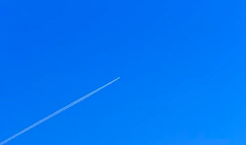 Flying plane in blue sky Stock Photos