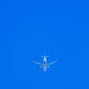 Flying plane in a cloudless sky Foto stock
