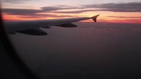 Flying Plane by passenger view from window seat, sunset Stock Footage 136901520