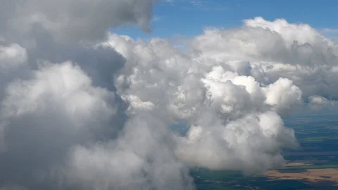Flying in a plane through the fluffy, snow-white clouds. Spectacular view from Stock Footage 126359067