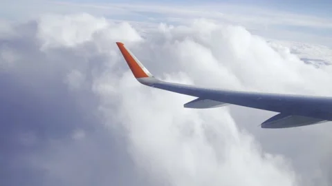 Flying in a plane through the fluffy, snow-white clouds. Spectacular view from 스톡 동영상 232365042