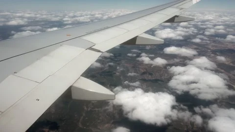 Flying by plane - view from the window porthole of the wing  plane during the fl Video stock 219944297