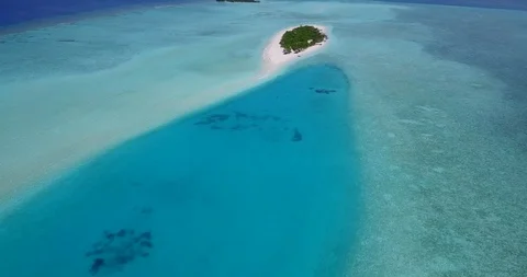 Flying point of view, dolly shot of tiny luscious tropical island in the Video stock 118435330