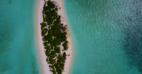 Flying point of view, dolly shot of tiny luscious tropical island in the Video stock 118435783