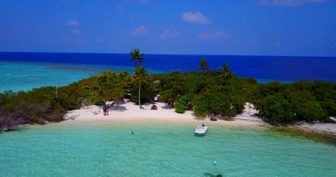 Flying point of view, dolly shot of tiny luscious tropical island in the Video stock 118437256