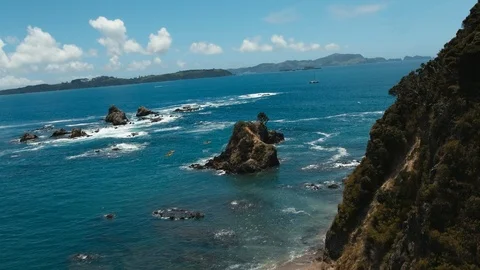 Flying point of view sunny New Zealand coastline with clear blue water Stock Footage 90268832